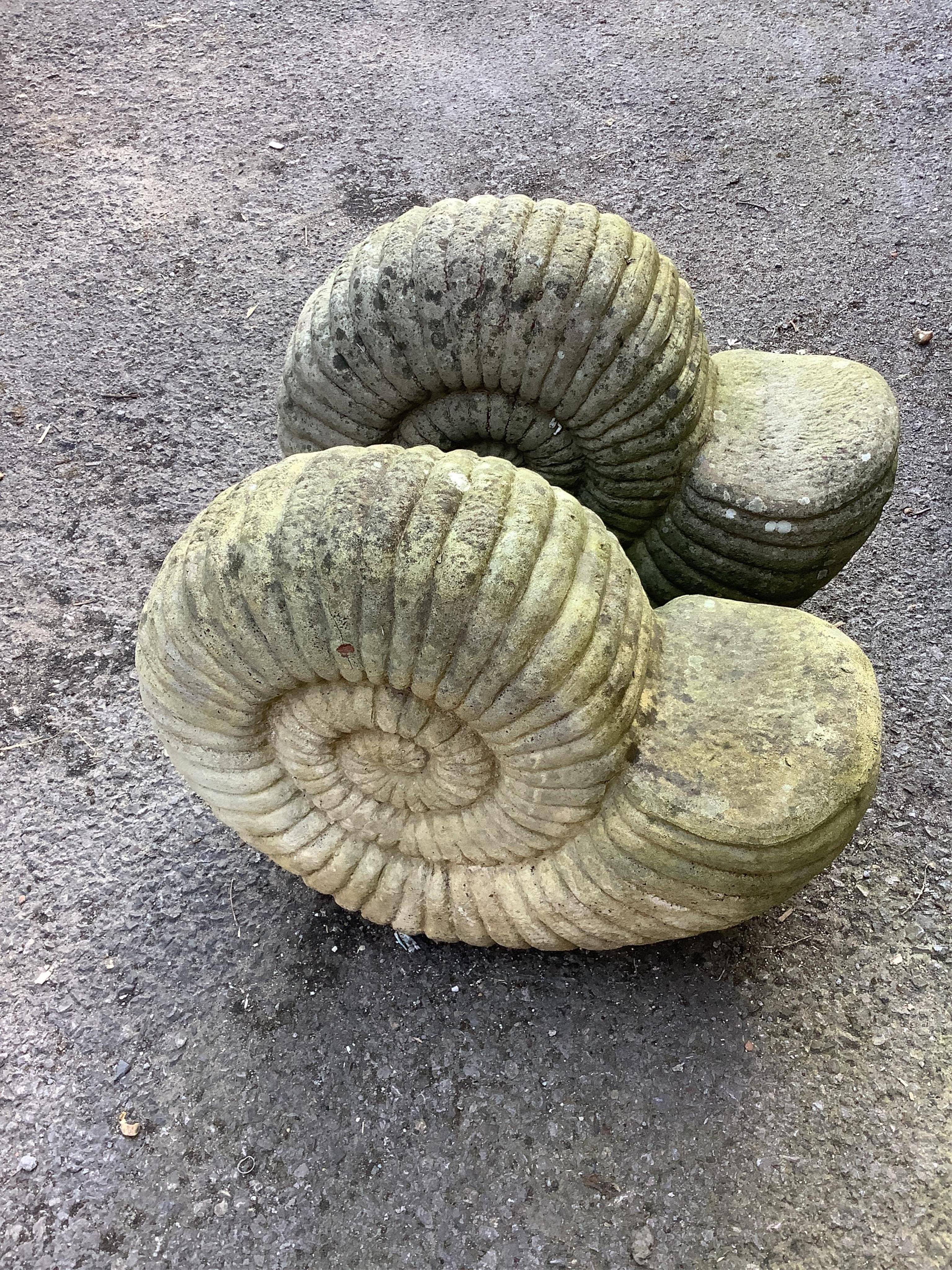 A pair of reconstituted stone 'ammonite' garden ornaments, length 47cm, height 40cm. Condition - fair